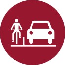 Icon of a red circle with a person riding a bicycle with a barrier between them and the car in white